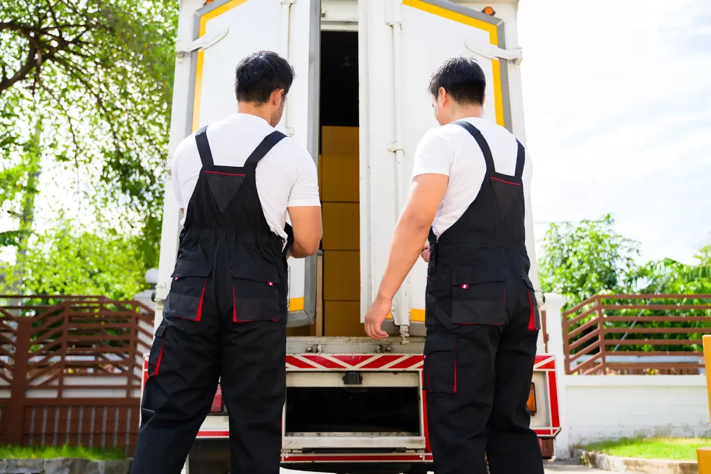 Two workers opening the back door of the moving truck