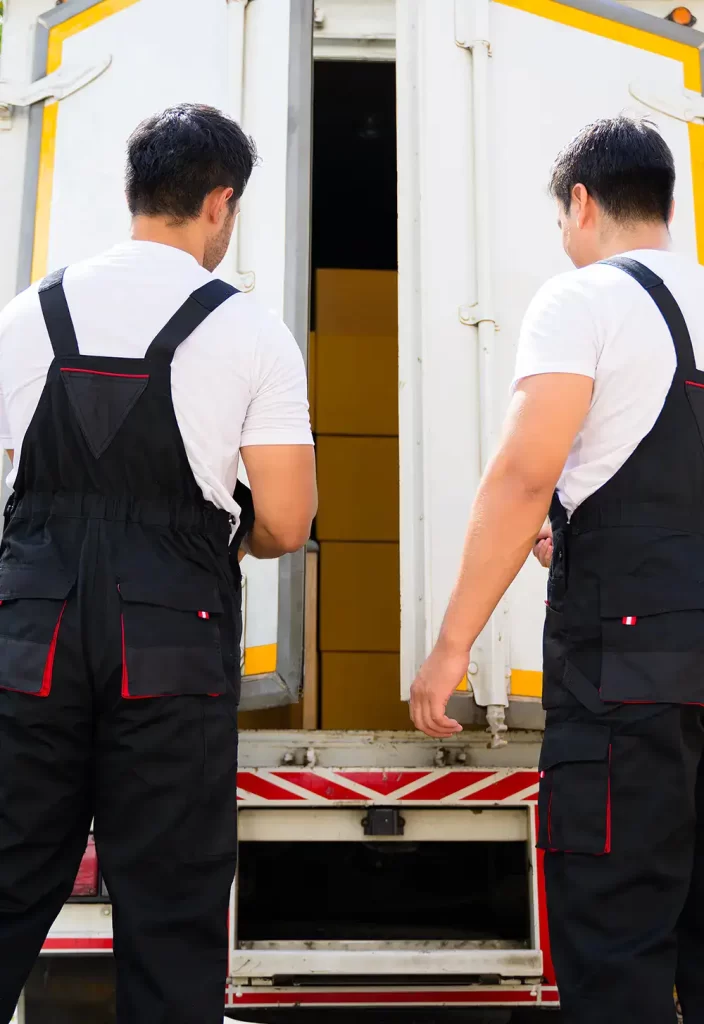 Two workers opening the back door of the moving truck